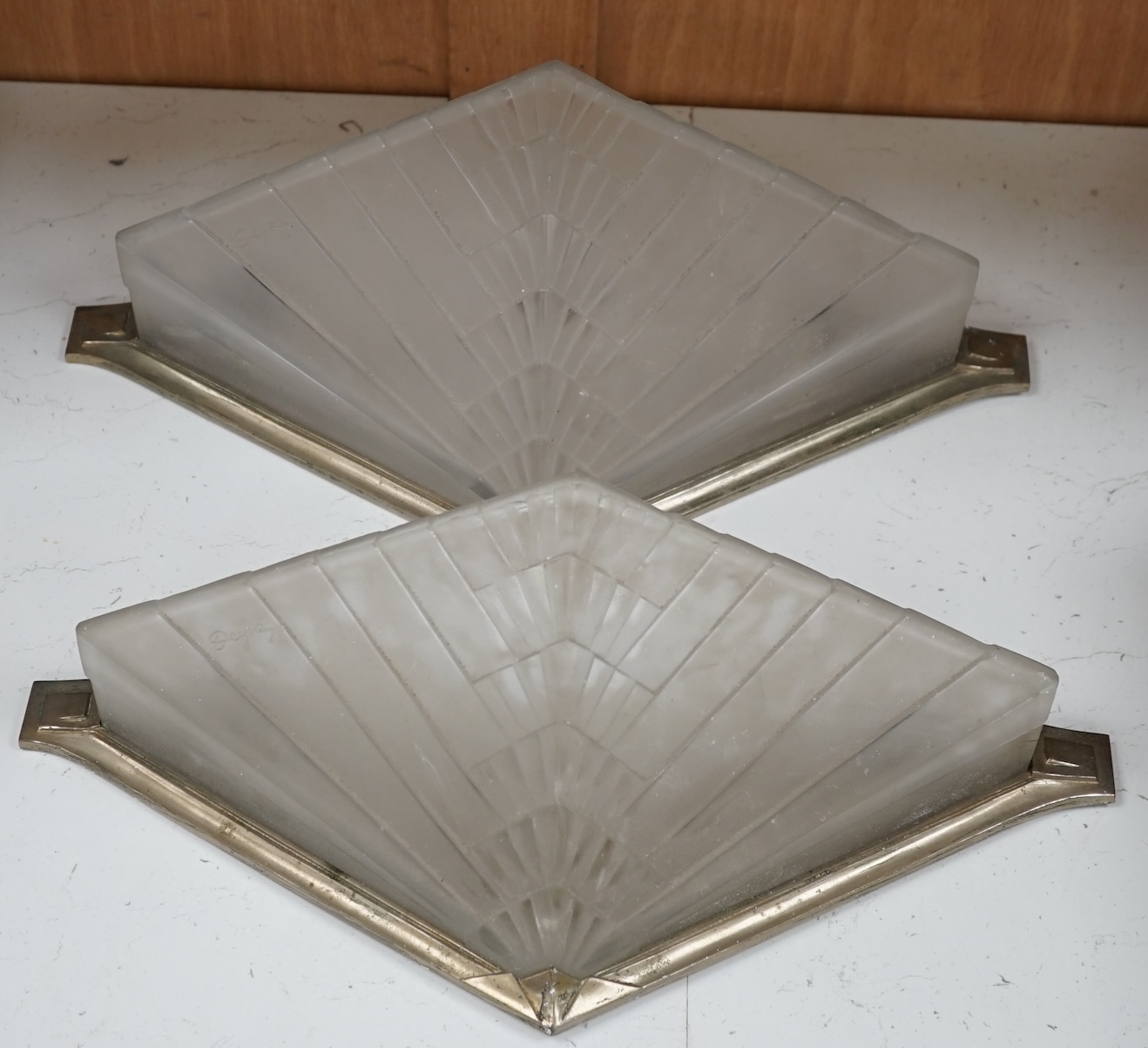 Two Art Deco wall lights with chrome frames by Degue, 40cm wide. Condition - fair, requires re wiring.